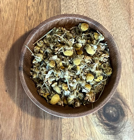 Wooden bowl of Egyptian Chamomile Flowers Loose Leaf Close up